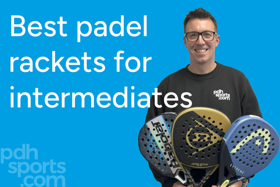 Man holding three padel rackets on blue background